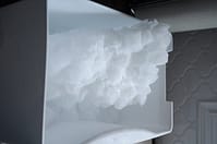 Ice block from ice maker created by warm drafts from opening drawer